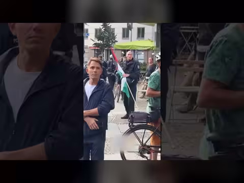 شرطي ألماني ينقذ العلم الفلسطيني